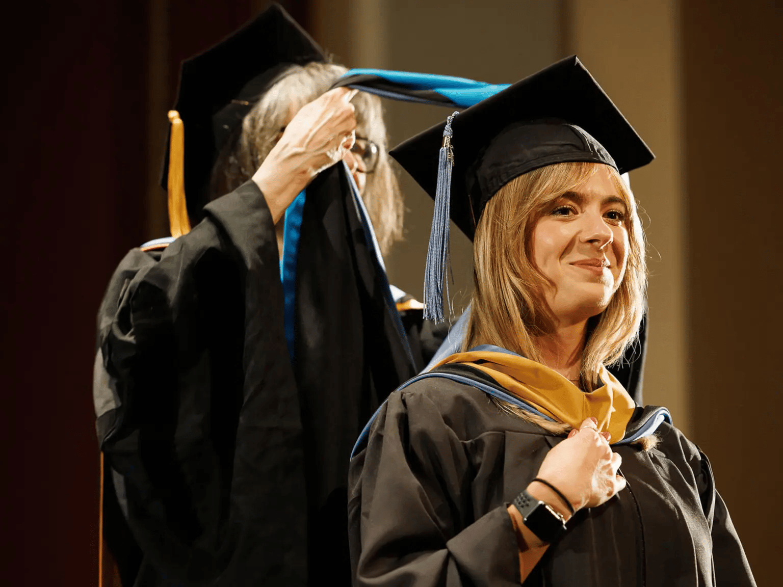 a person in a graduation gown and cap
