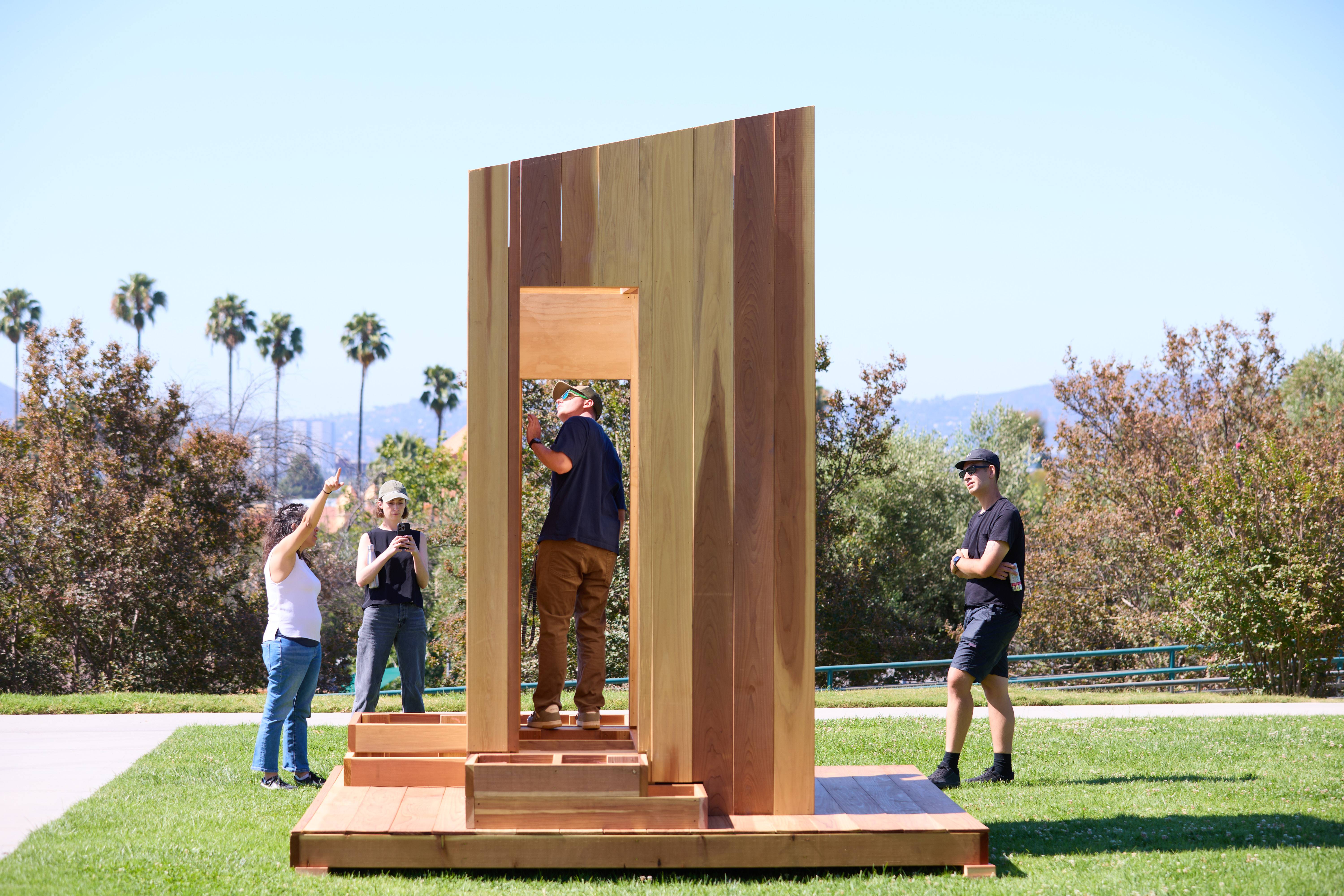 a group of people standing in a wood structure