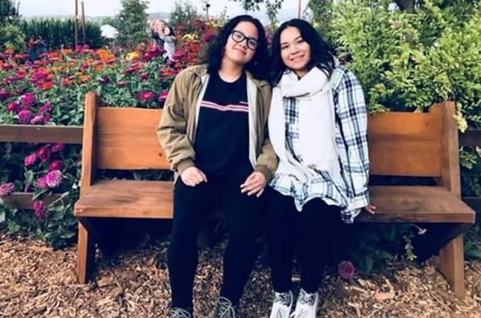 two women sitting on a bench