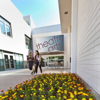 a group of women walking in a courtyard