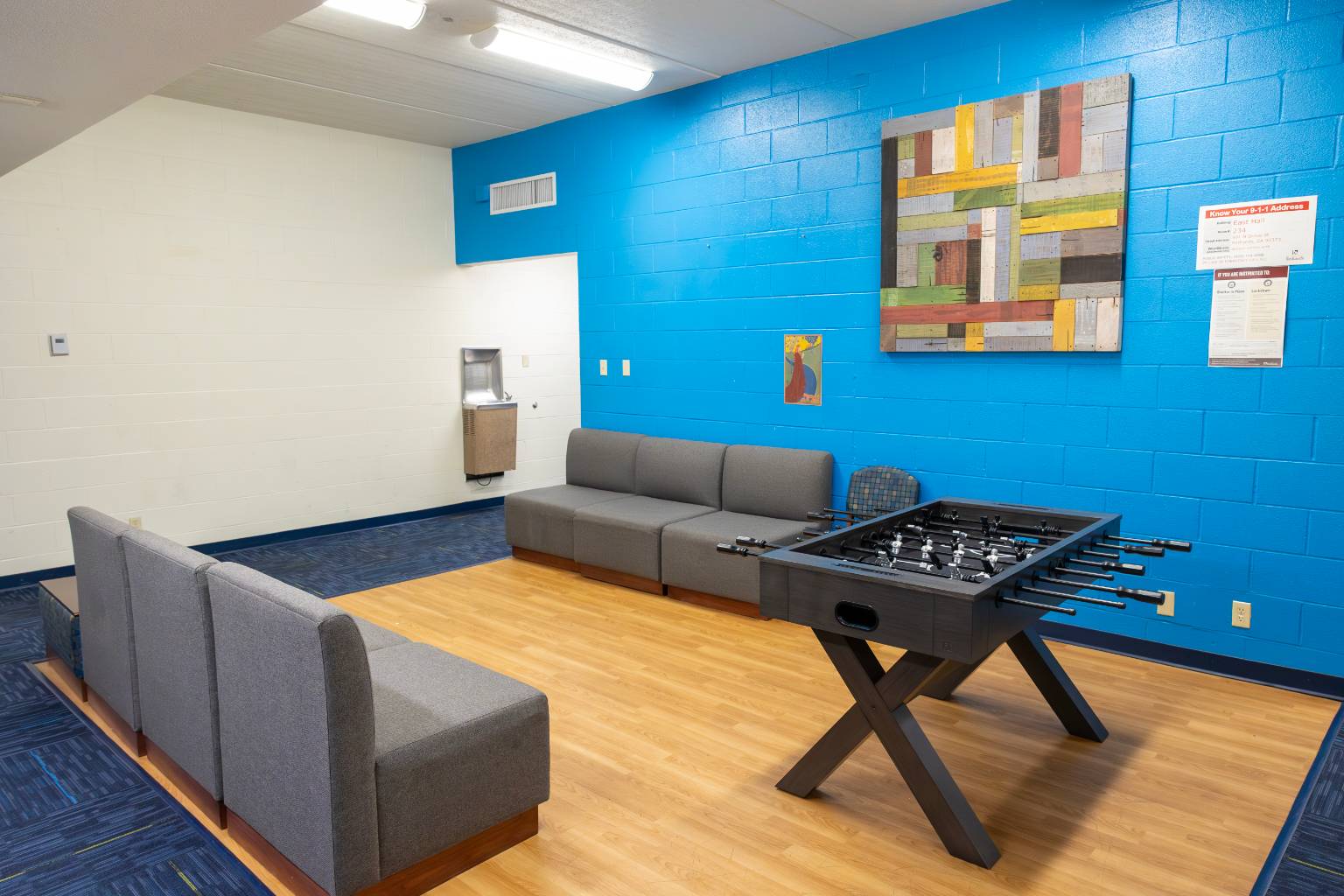 a room with a couch and foosball table