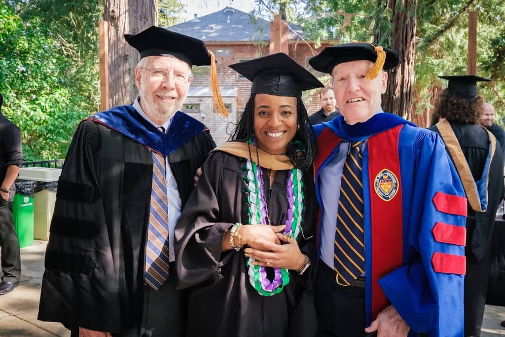a group of people in graduation gowns and caps