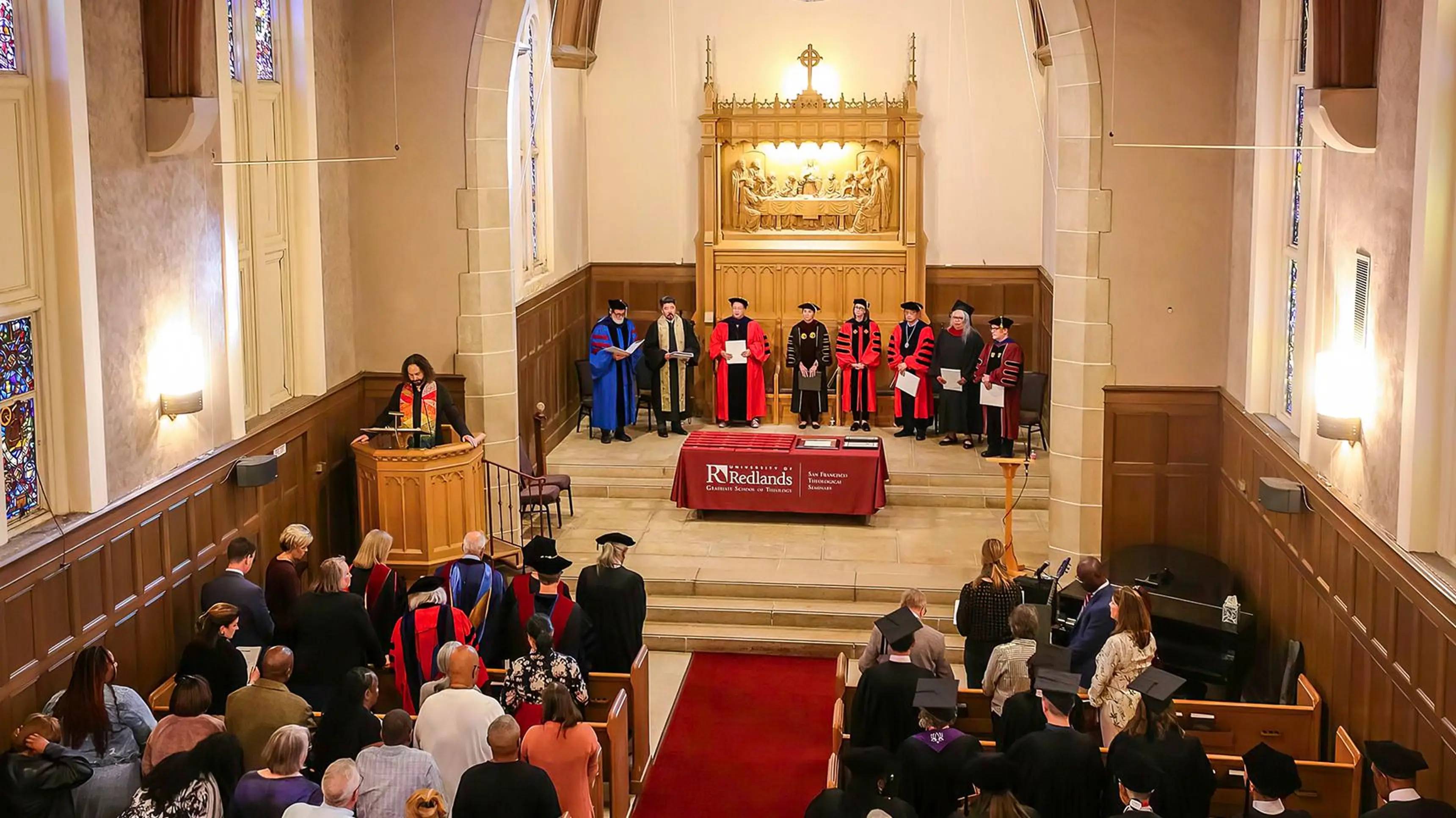 a group of people in robes standing on a stage in a church
