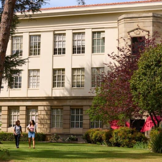a group of people walking in front of a building