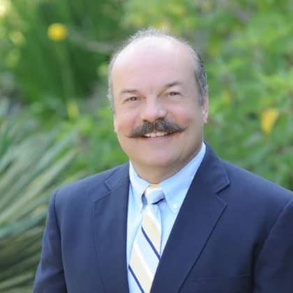 a person with a mustache smiling