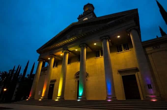 a building with a clock tower and colorful lights