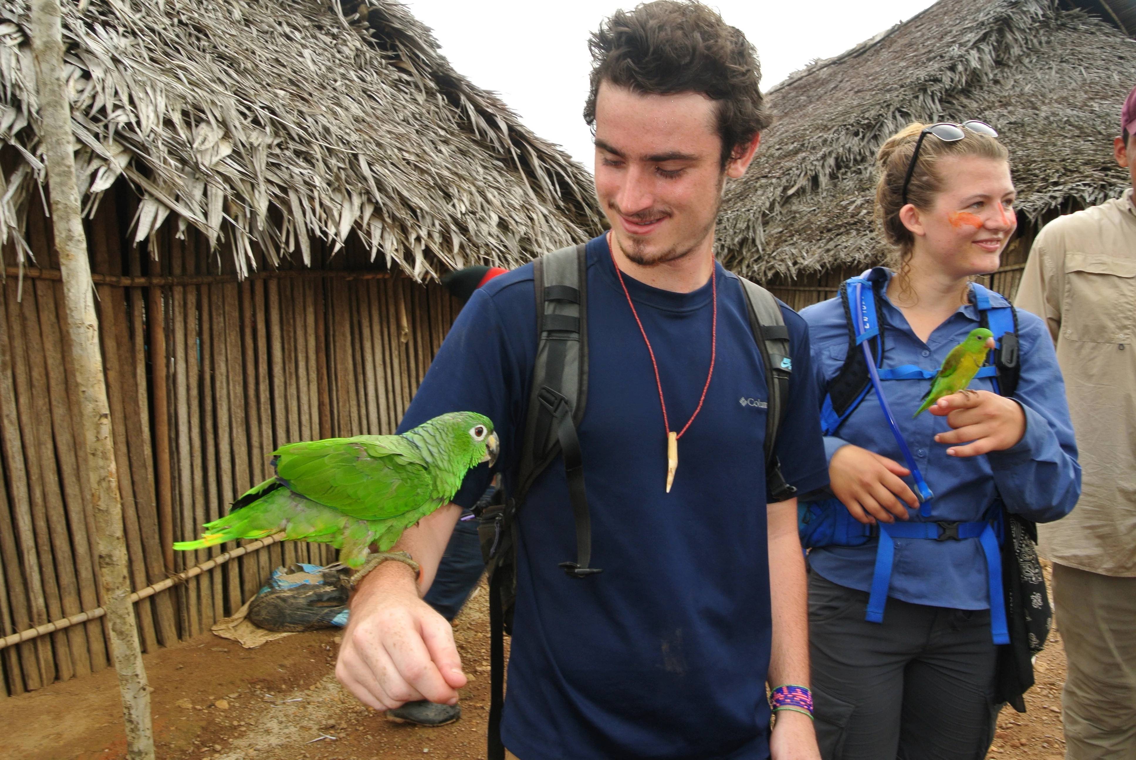 a person with a parrot on his arm