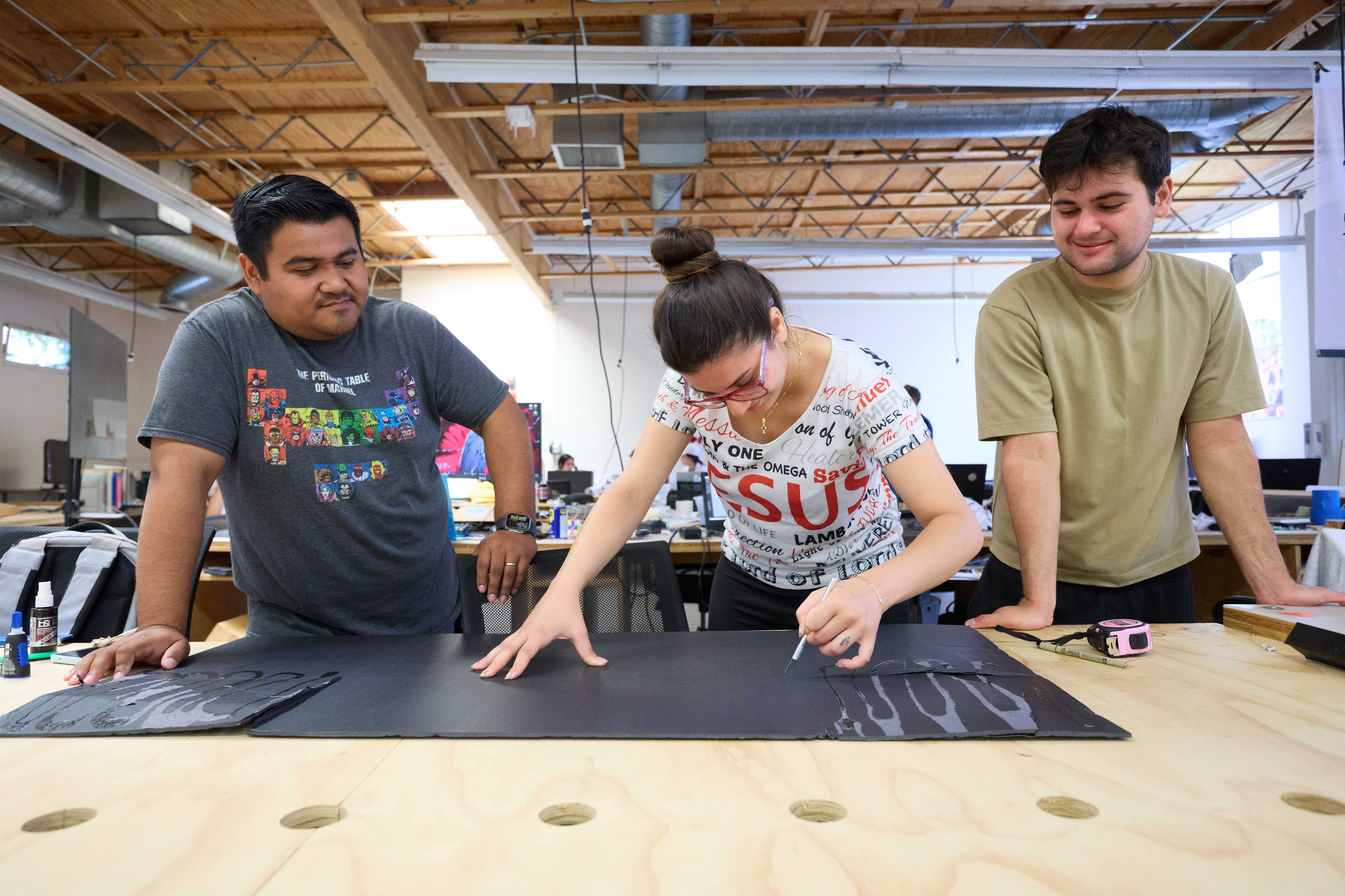 a group of people standing around a table