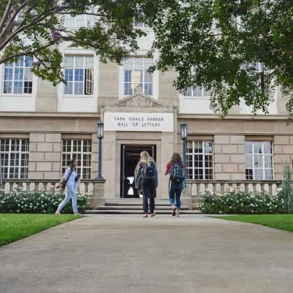a group of people walking into a building