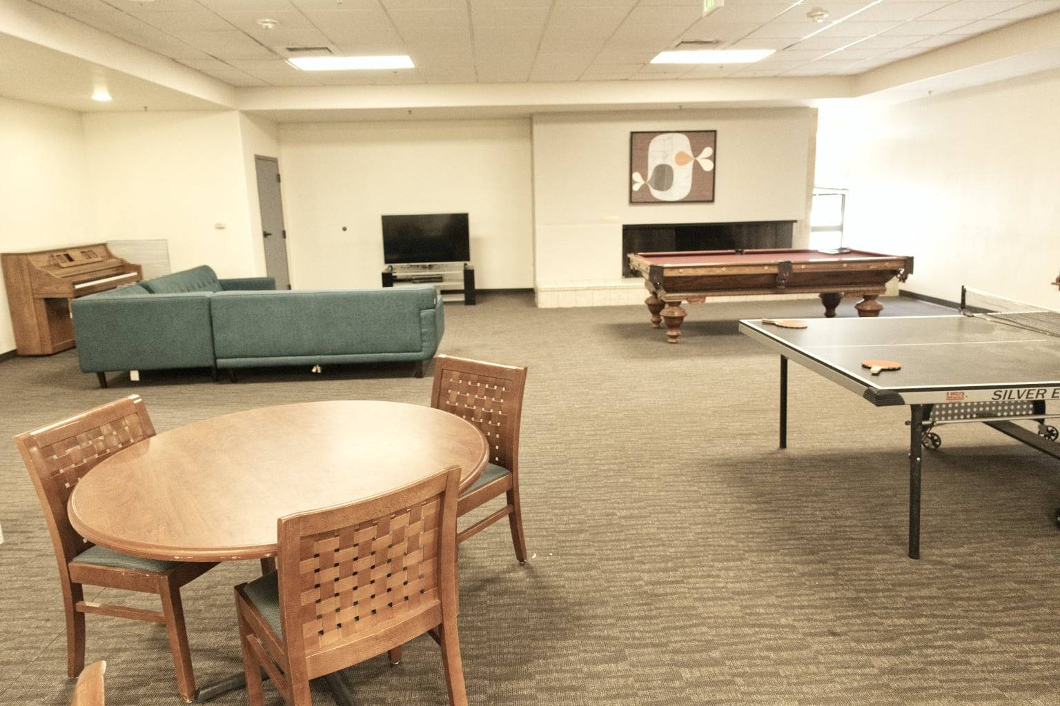 a room with a pool table and a couch