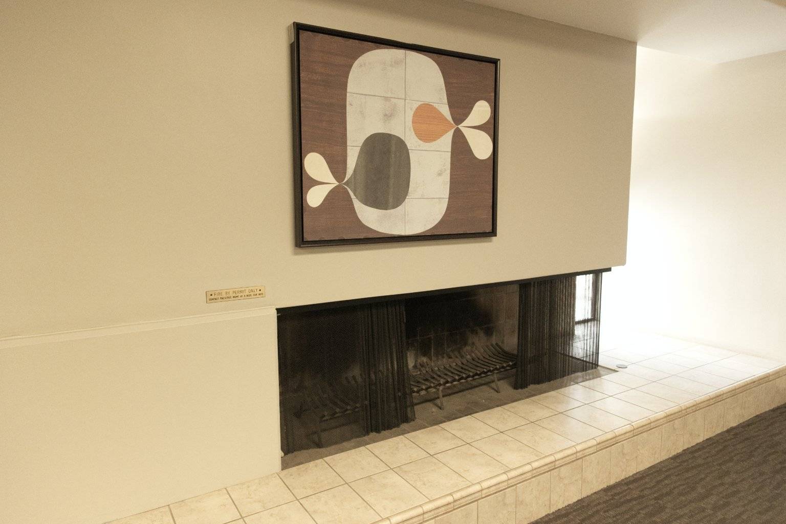 a fireplace with a painting on the wall
