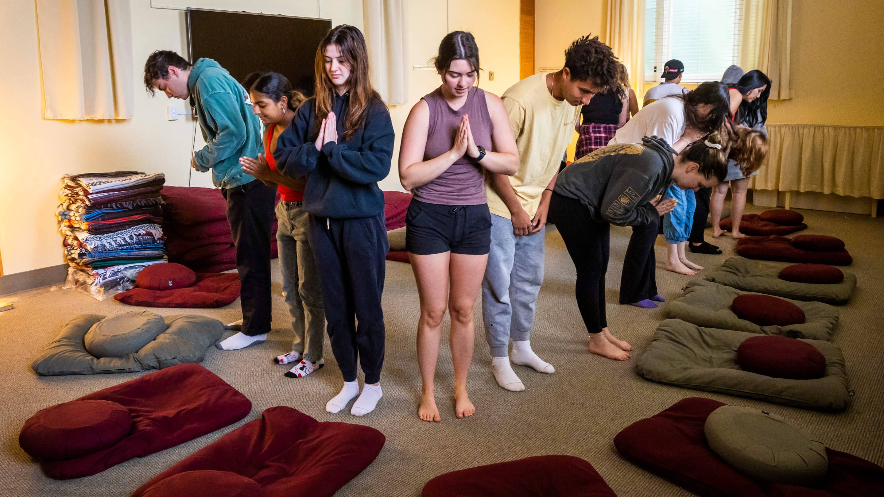 a group of people standing in a circle with their hands together