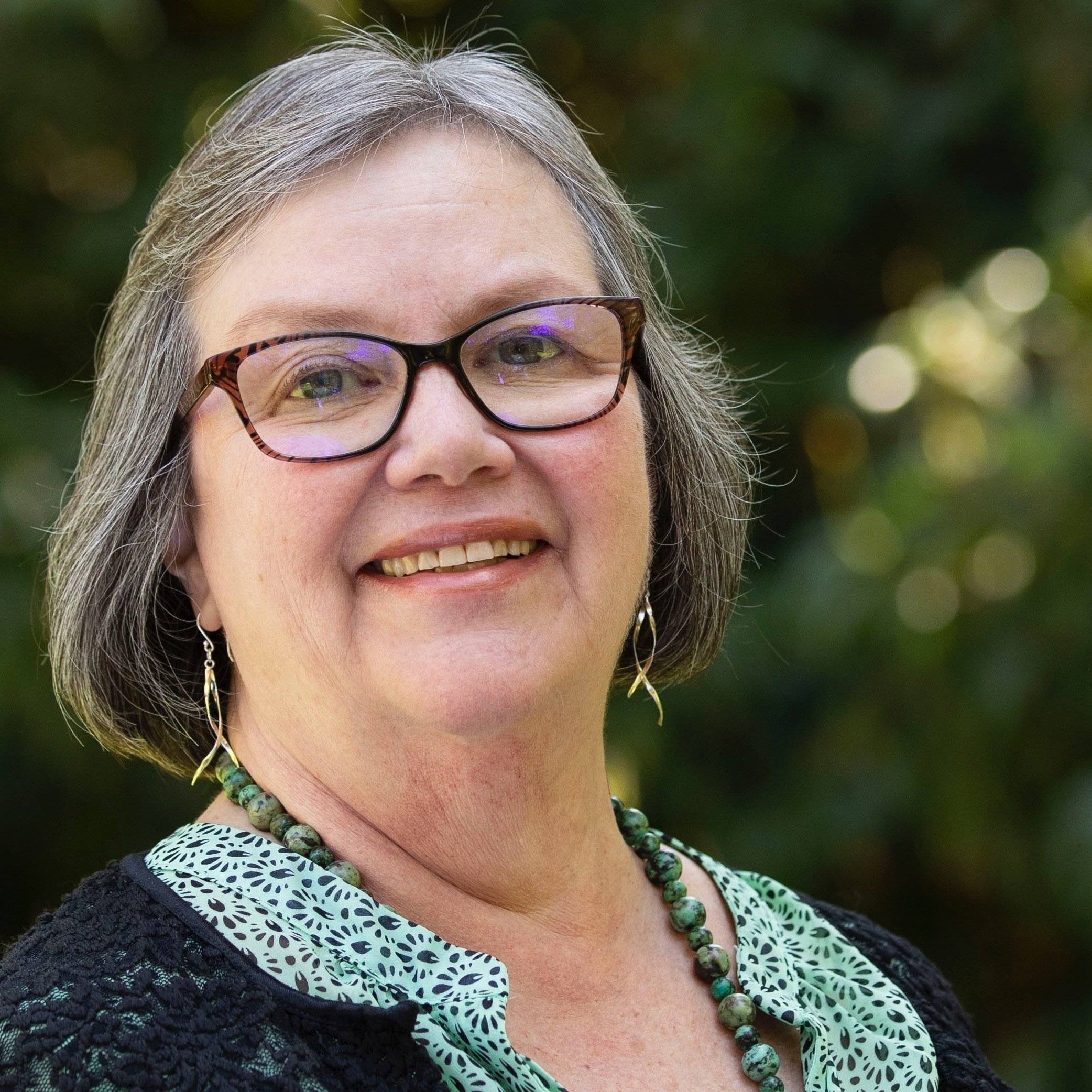 a person with glasses and a green shirt