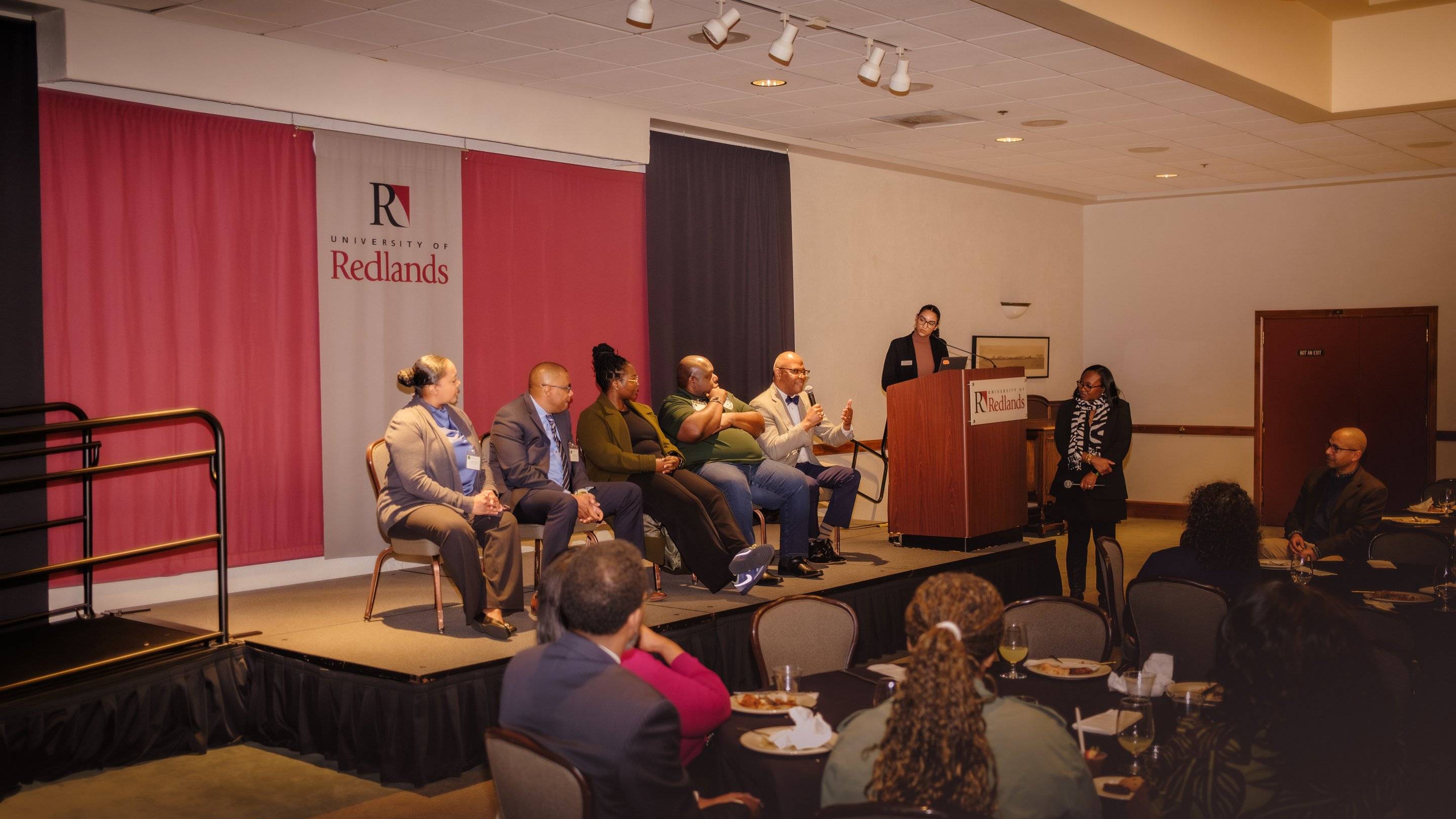 a group of people sitting on a stage
