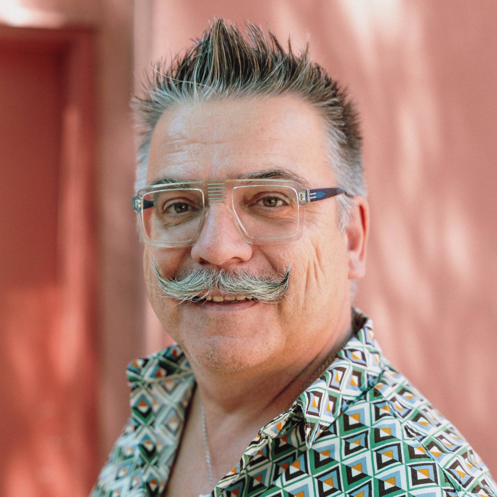 a person with a mustache and glasses