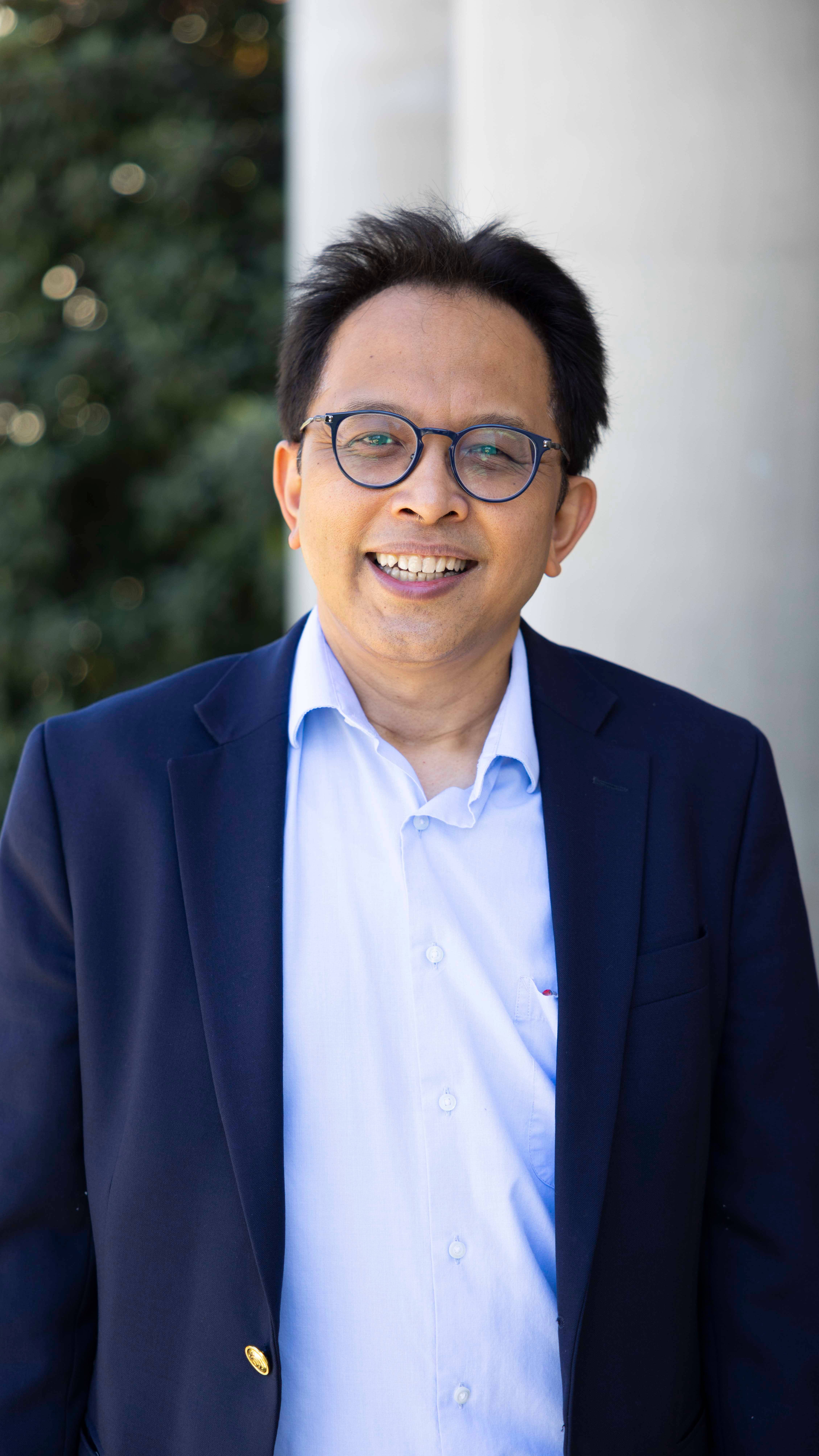 a person wearing glasses and a suit jacket