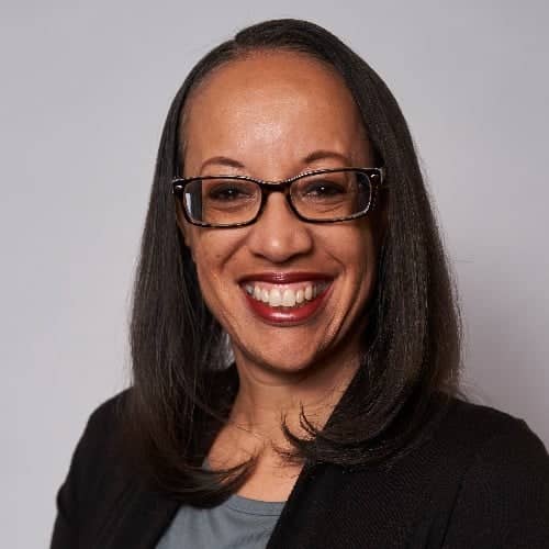 a person wearing glasses smiling