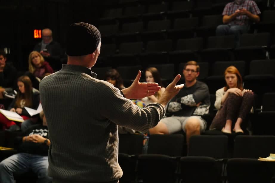 a person standing in front of a crowd