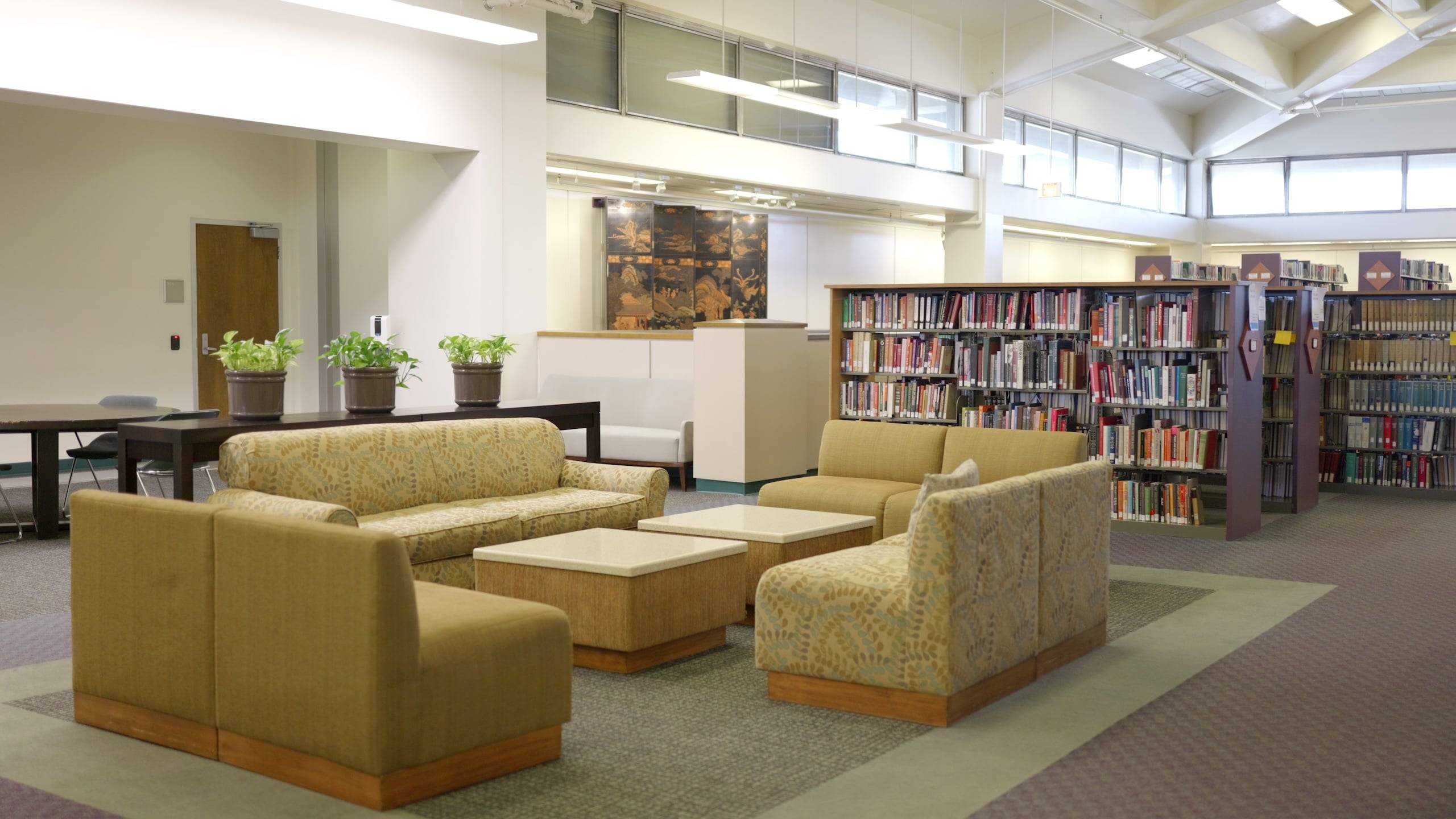 a library with couches and tables