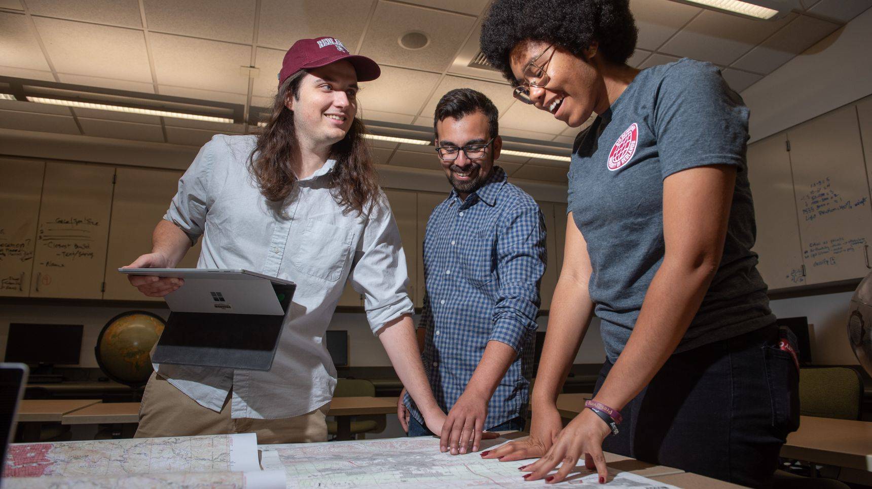 a group of people looking at a map