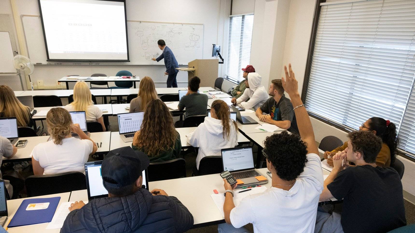 a group of people sitting in a classroom