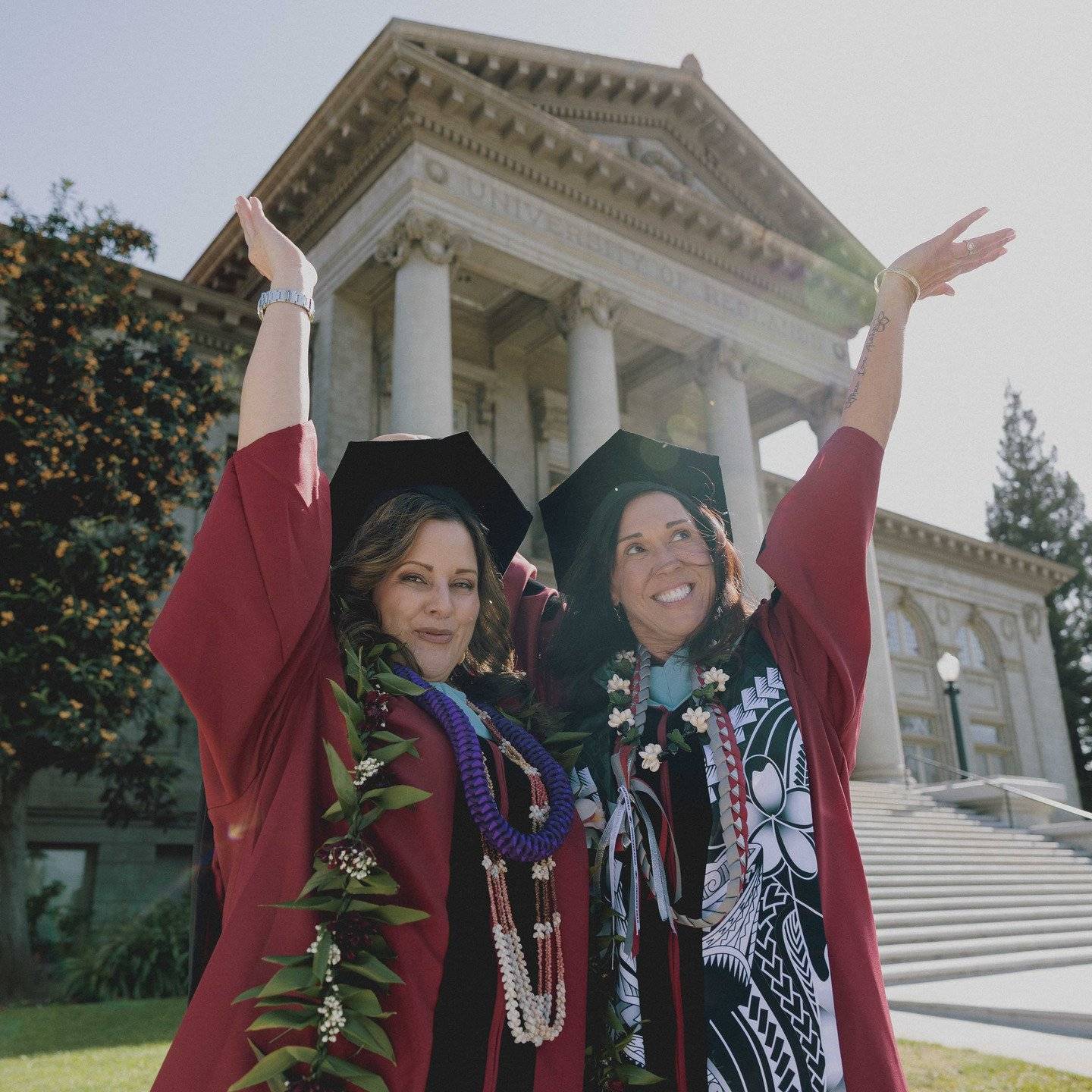 a group of women in graduation gowns and caps posing for a picture