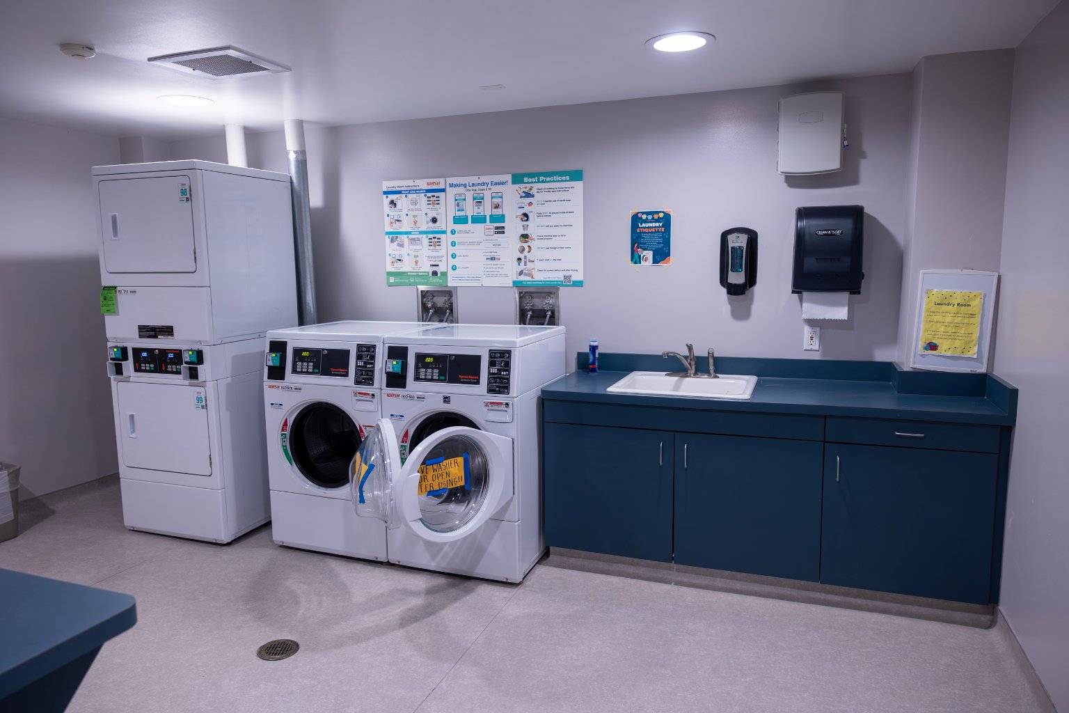 a laundry room with washers and dryers