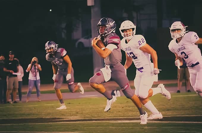 a group of people running on a field