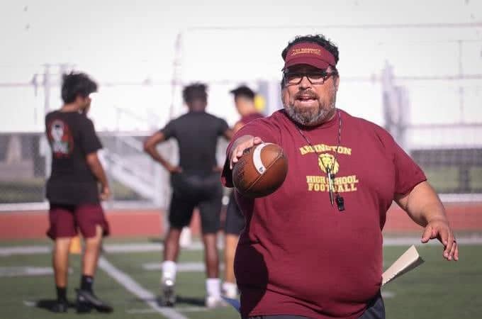 a person holding a football and a ball