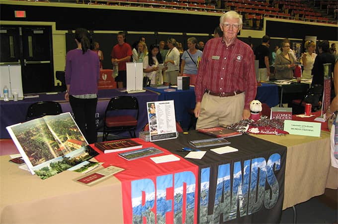 a person standing at a table with a table with a table with a table with a table with a table with a table with a table wi...