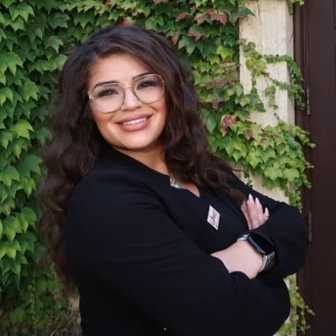 a person with glasses and a black jacket