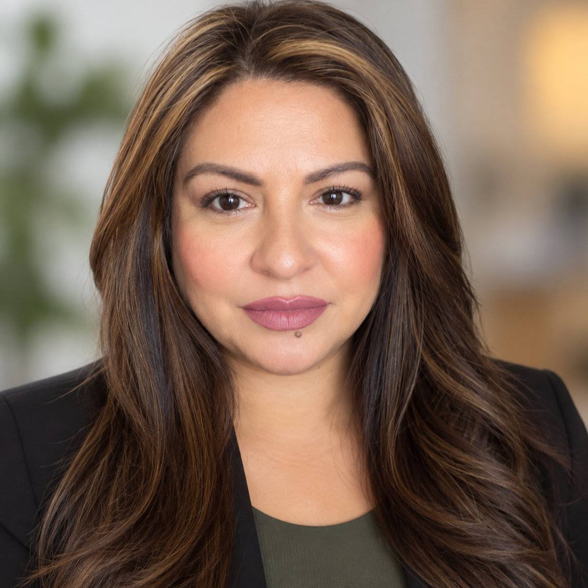a person with long brown hair and a black blazer