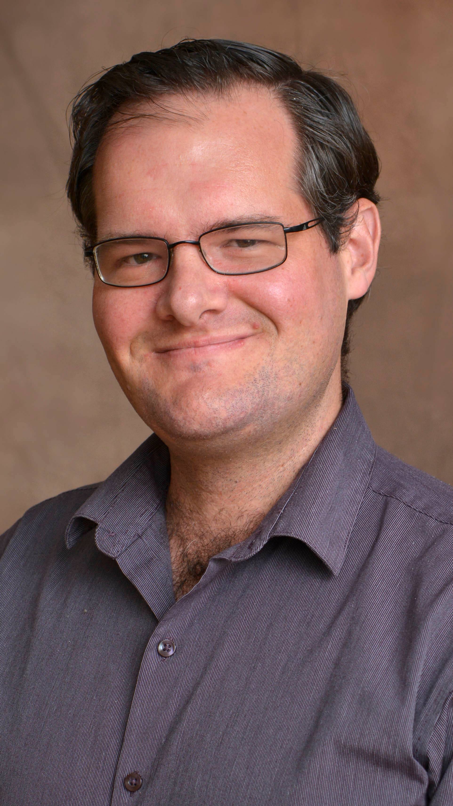 a person wearing glasses and a striped shirt