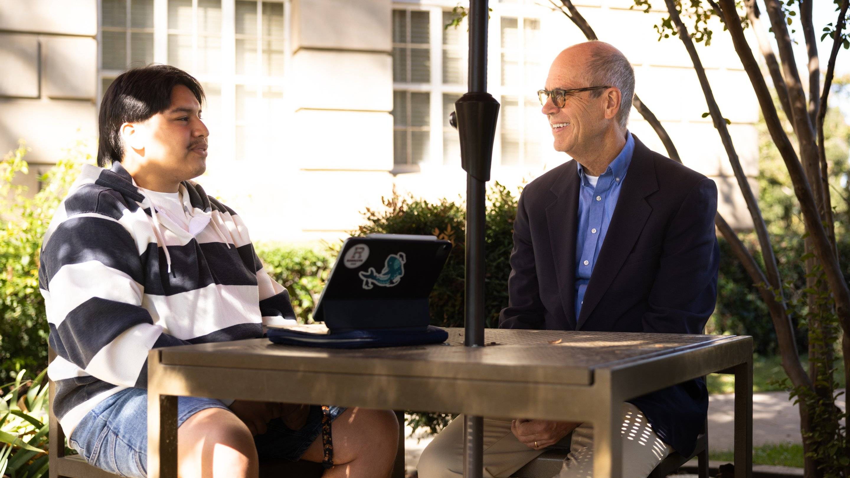 a person and person sitting at a table