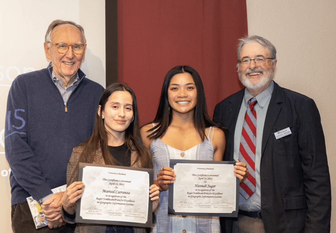 a group of people holding certificates