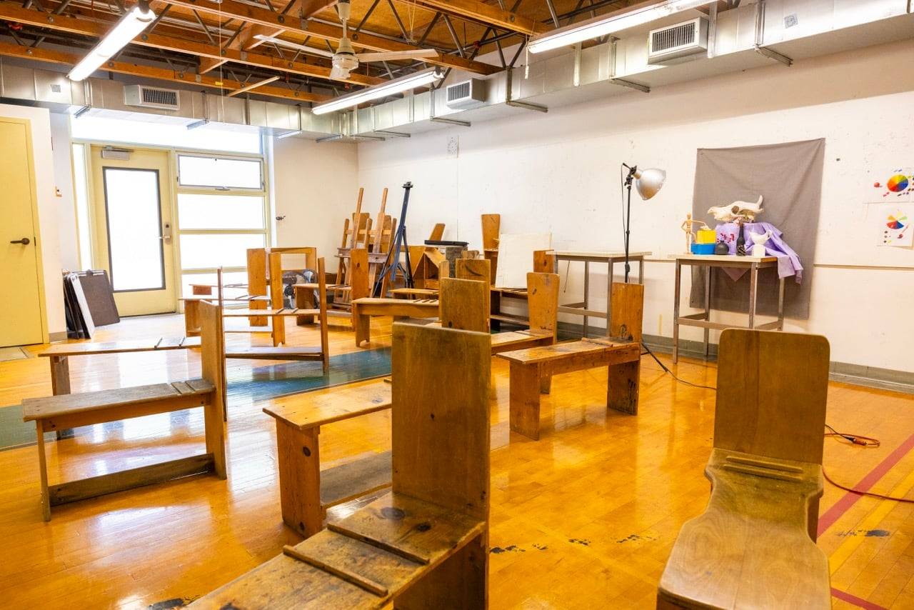 a room with wooden chairs and a table