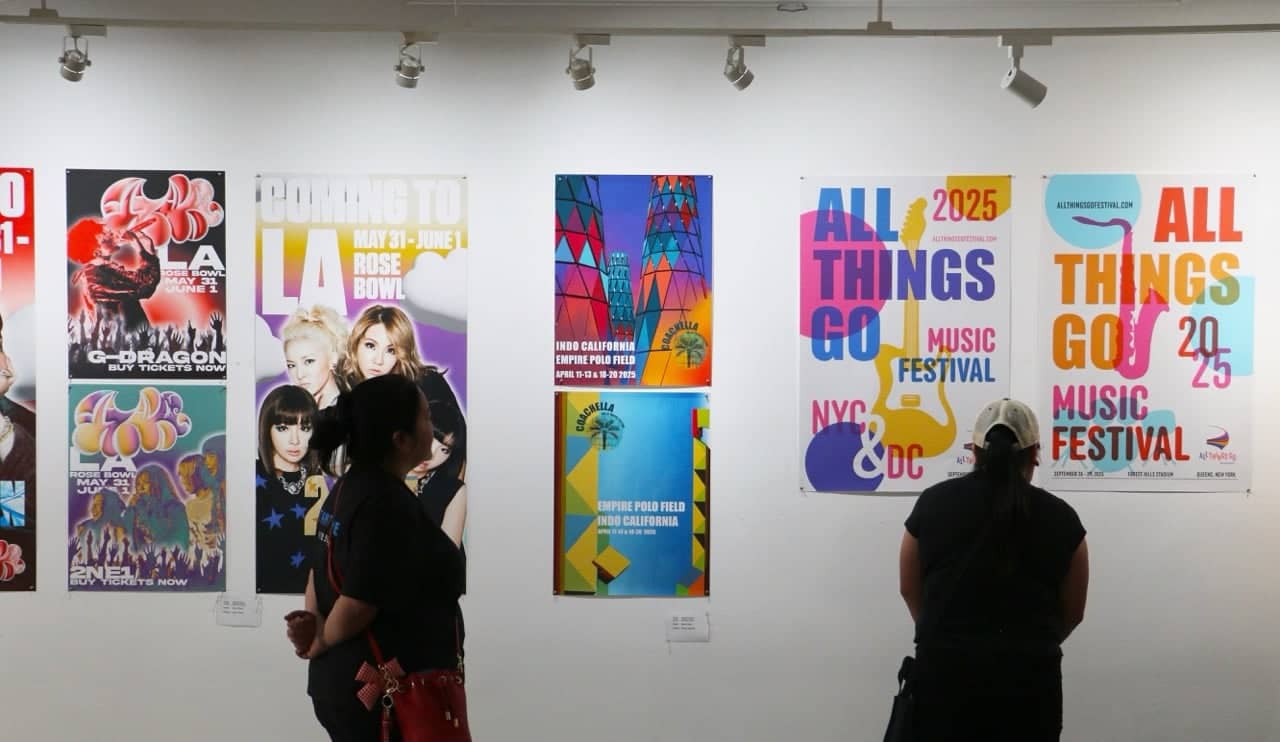a group of people looking at posters on a wall