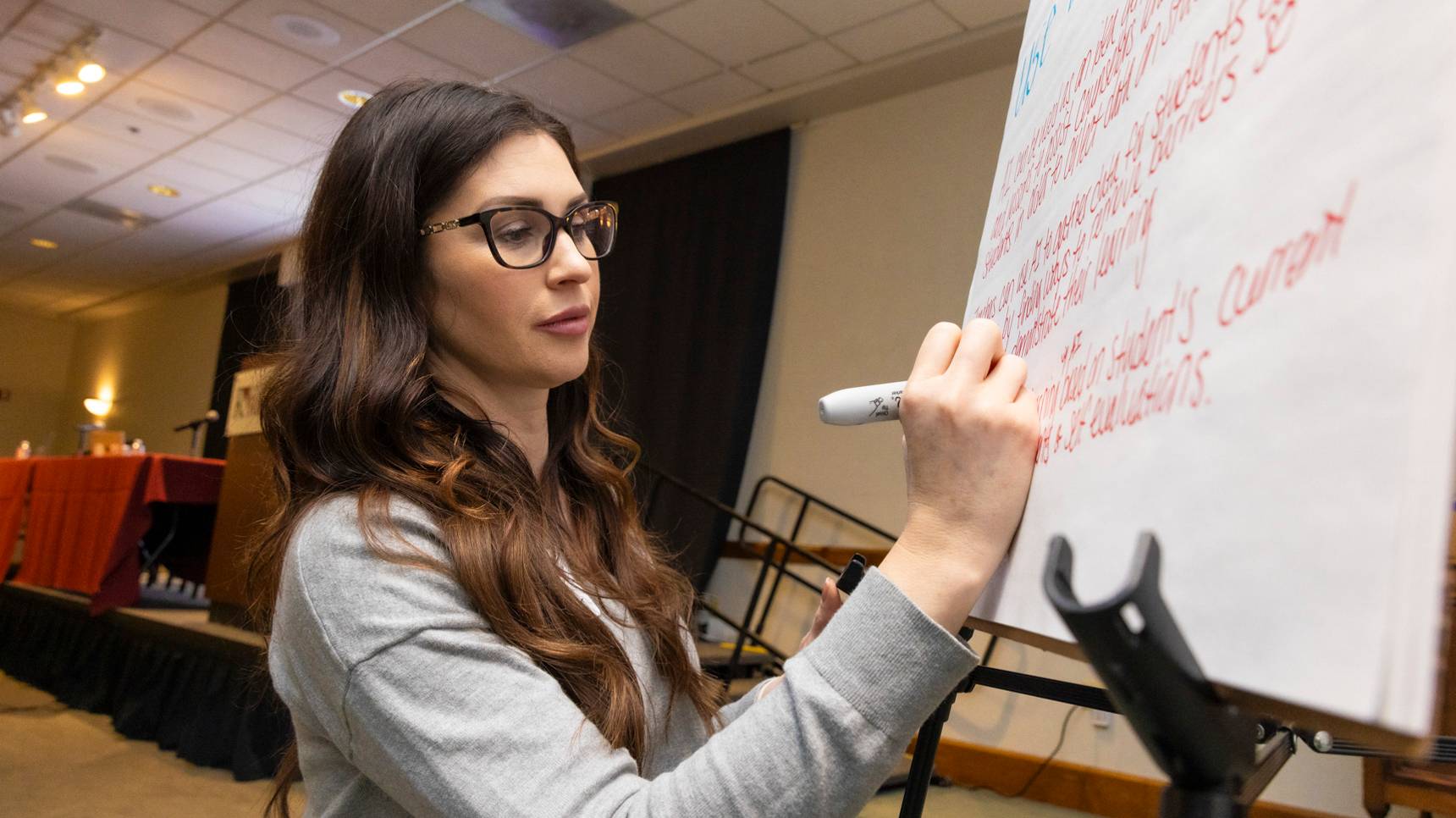 a person writing on a white board