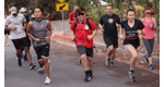 Group of students and teachers jogging across the streets.