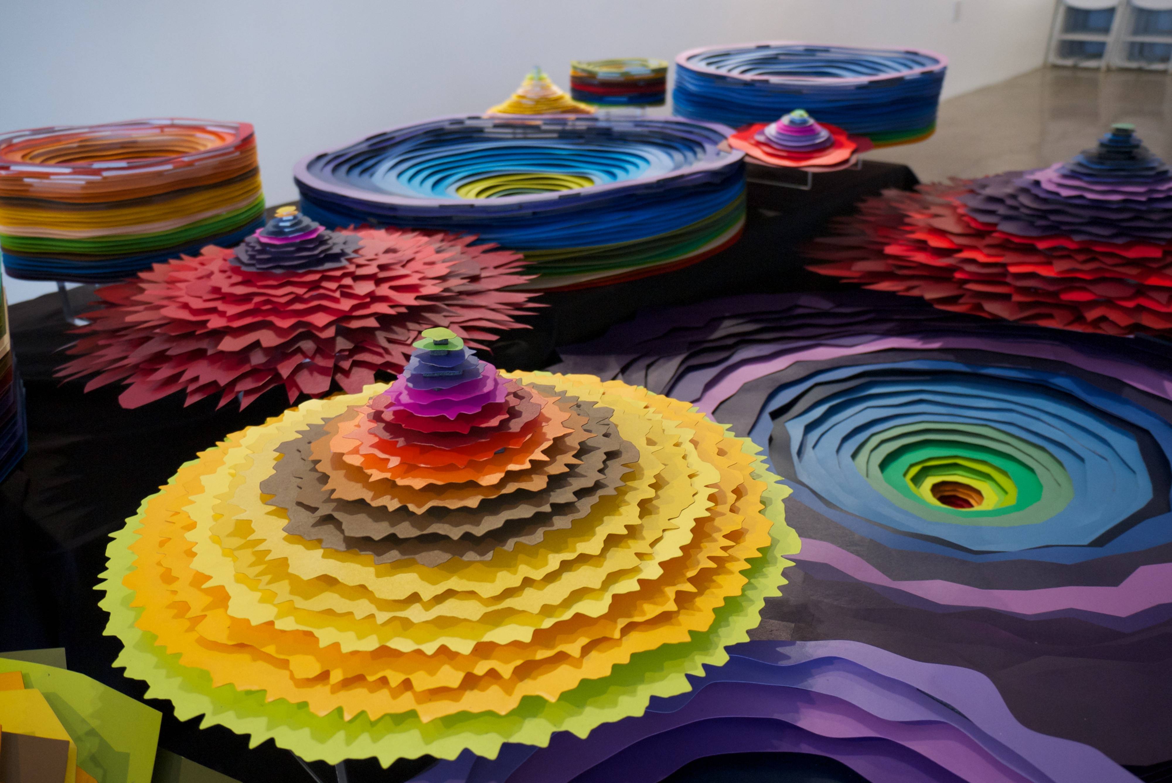 a group of colorful paper sculptures