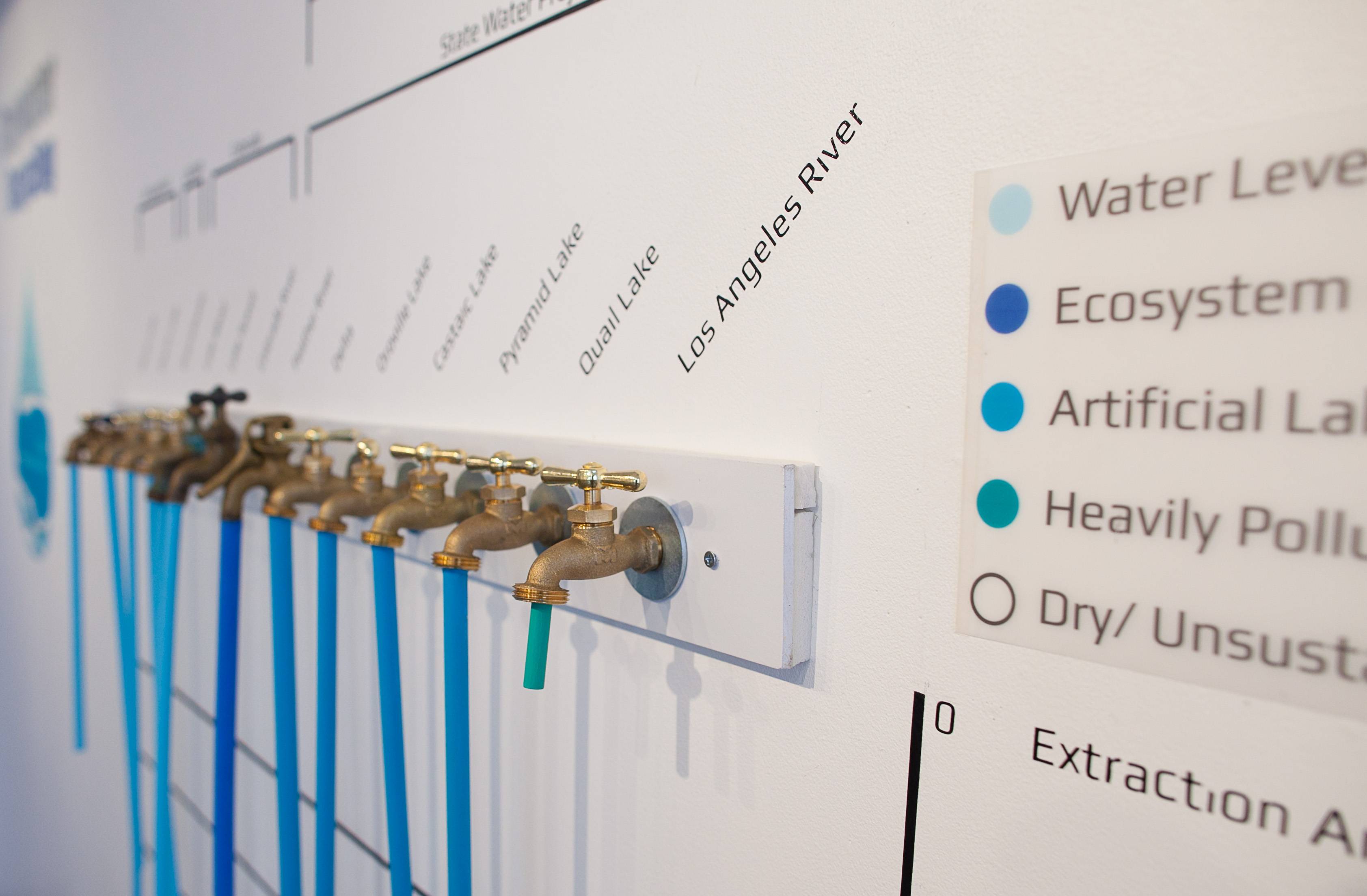 a row of faucets on a wall