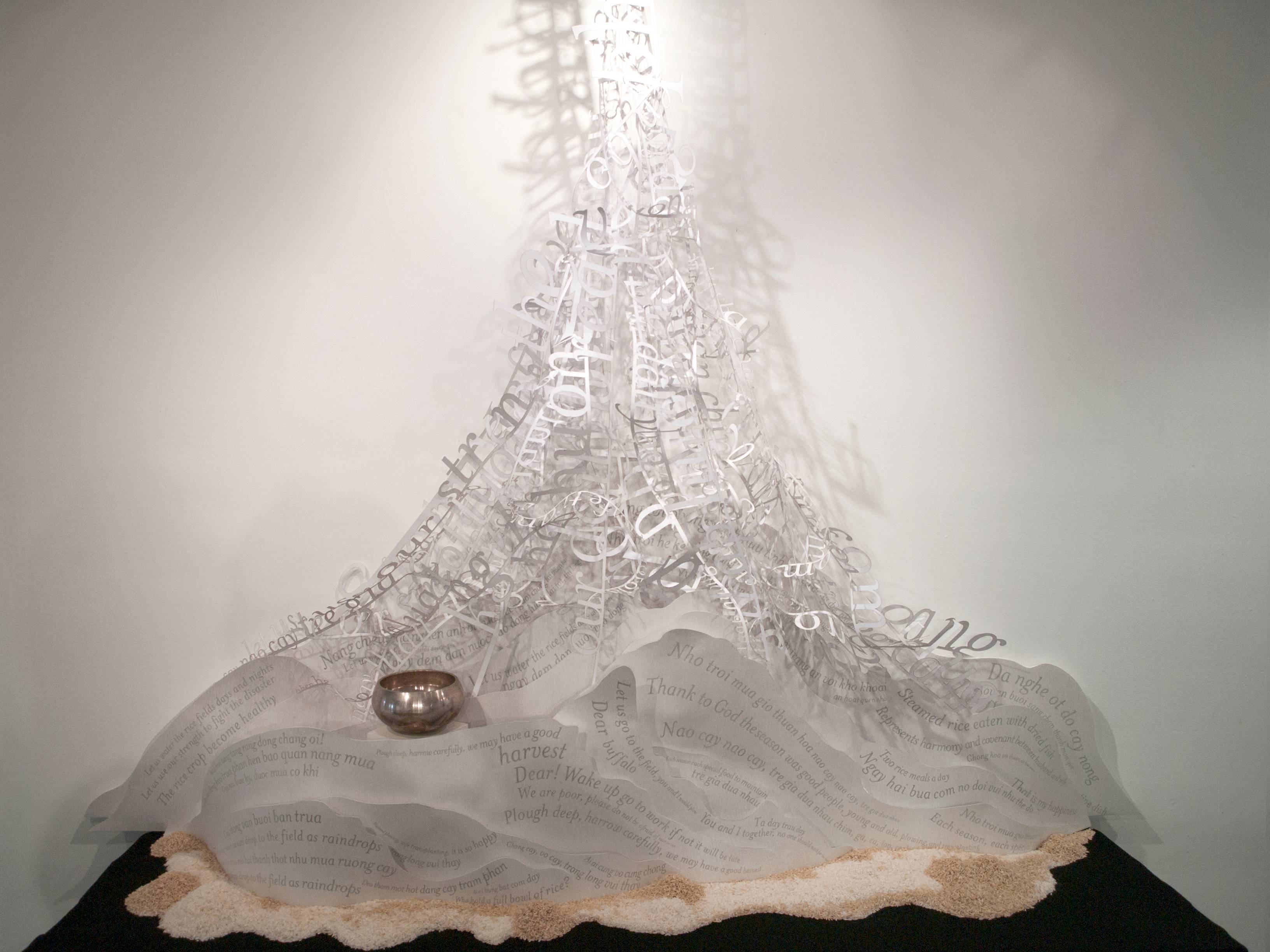 a sculpture of letters and words on a white surface