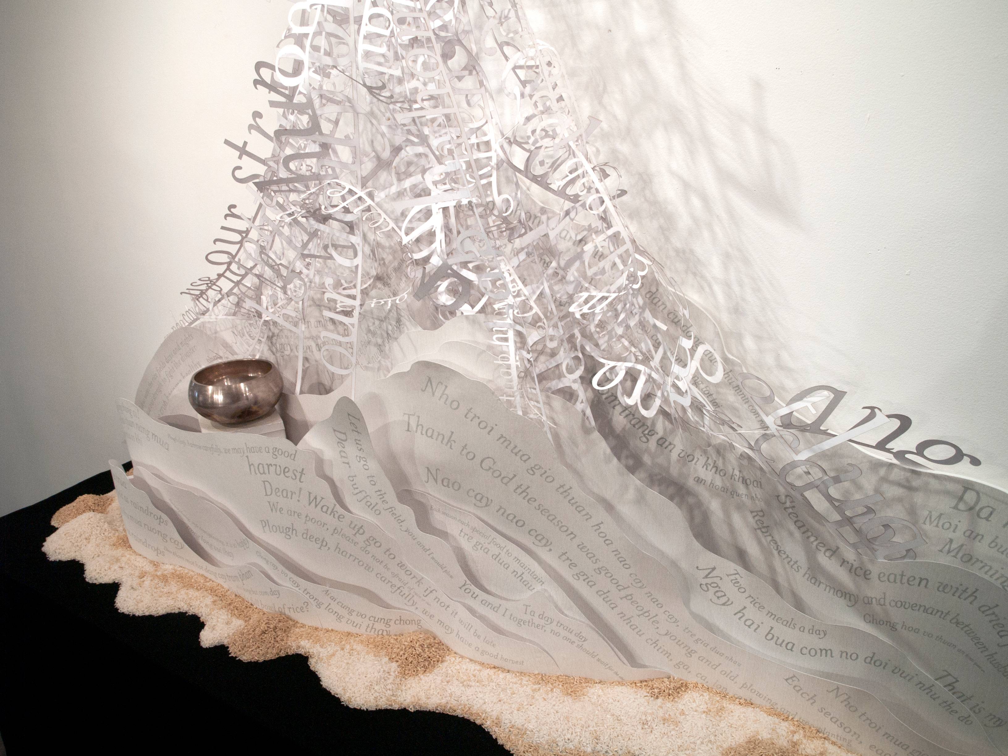 a sculpture of a silver ball and paper