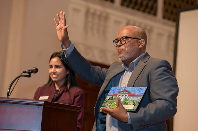 a person holding a picture and raising his hand