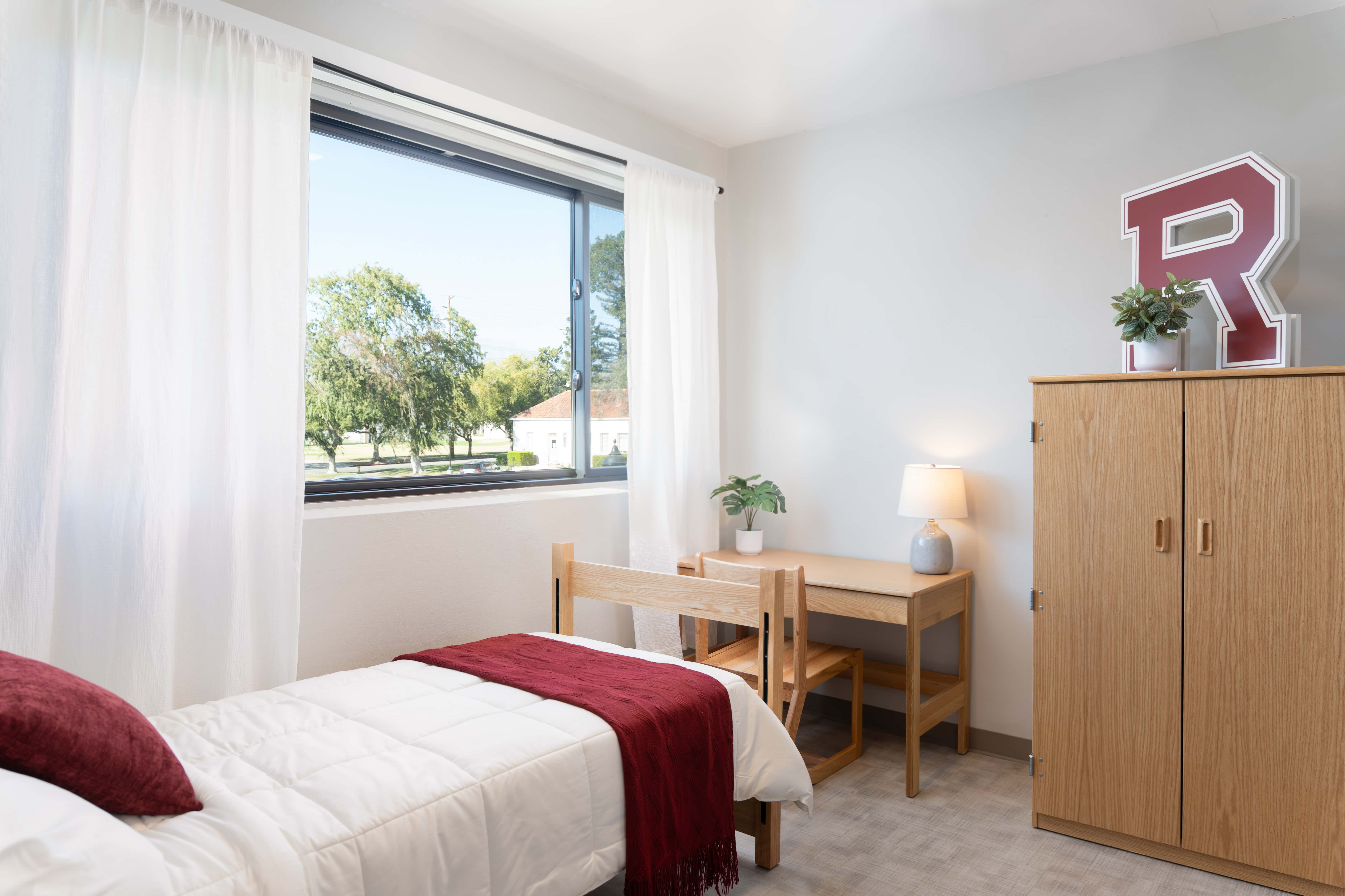 a bedroom with a bed and desk