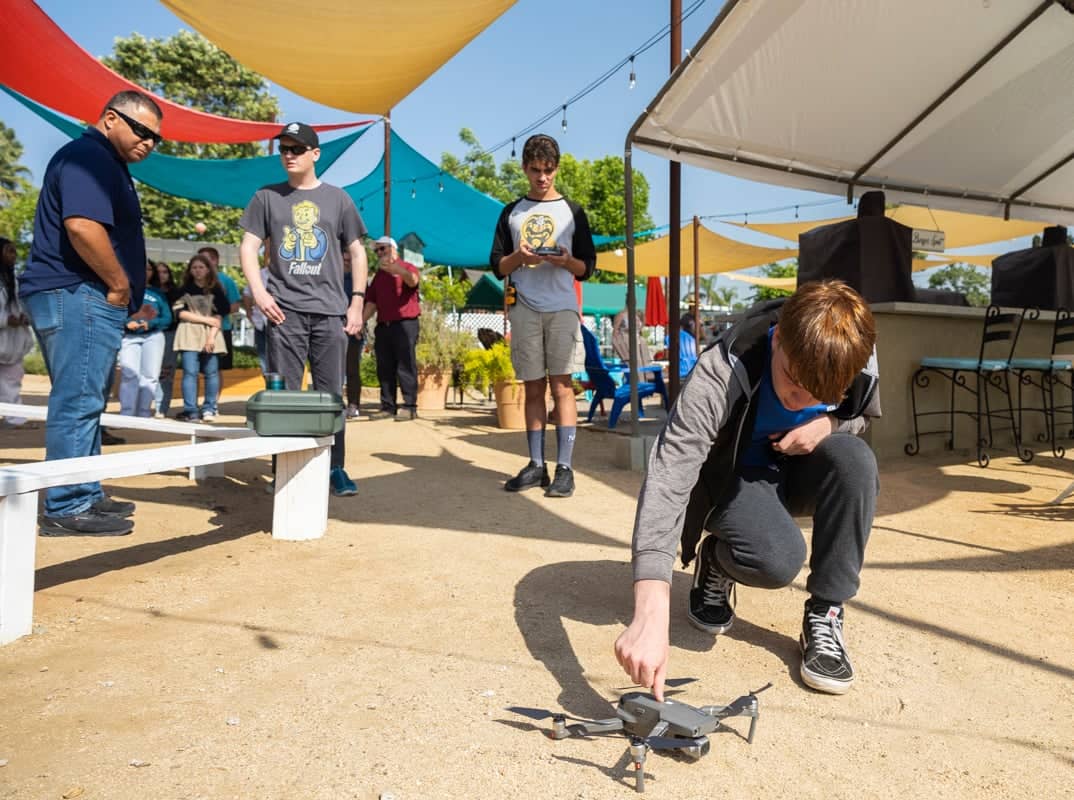 a group of people watching a drone