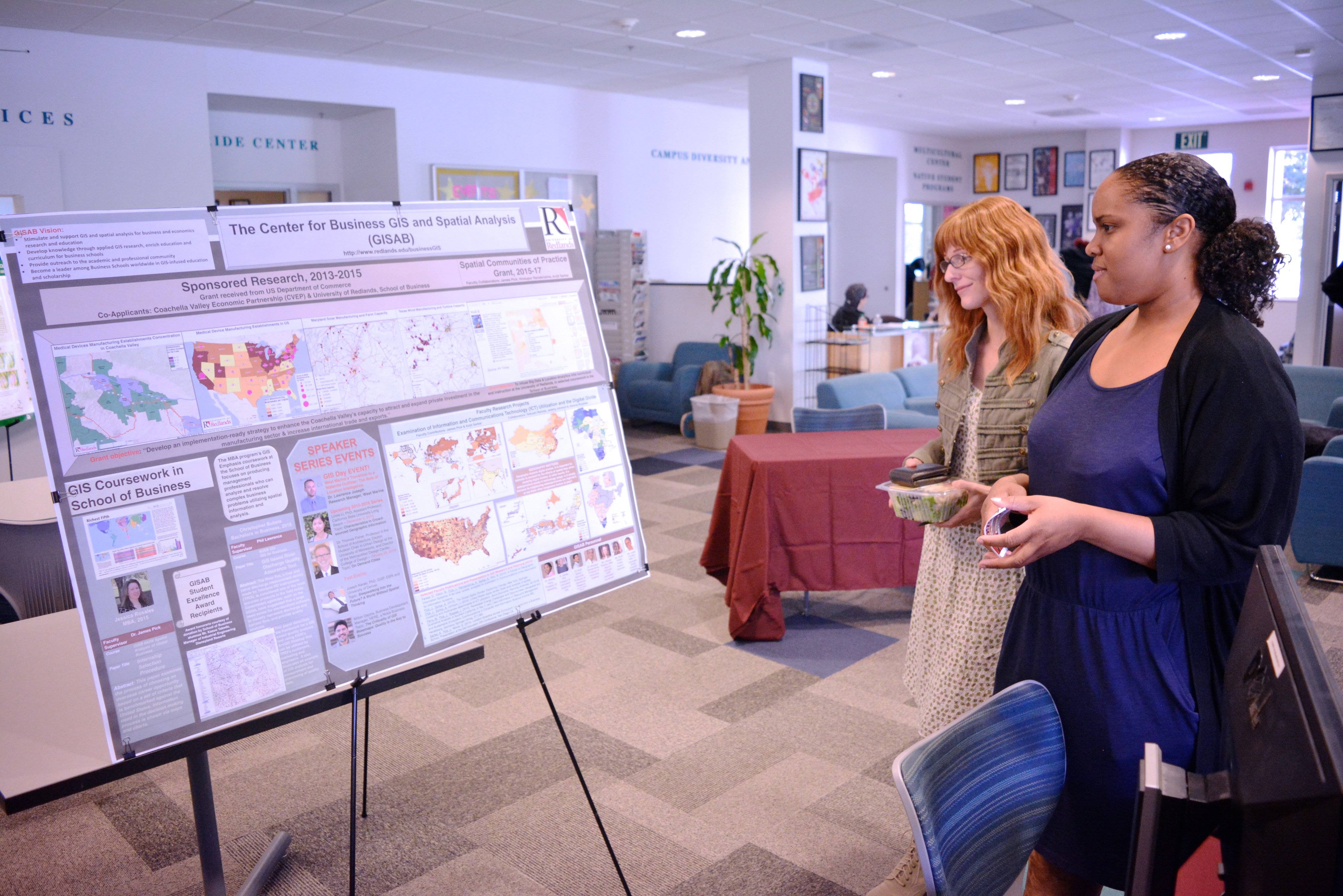 a group of women looking at a display board