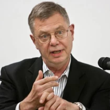 a person in a suit and glasses