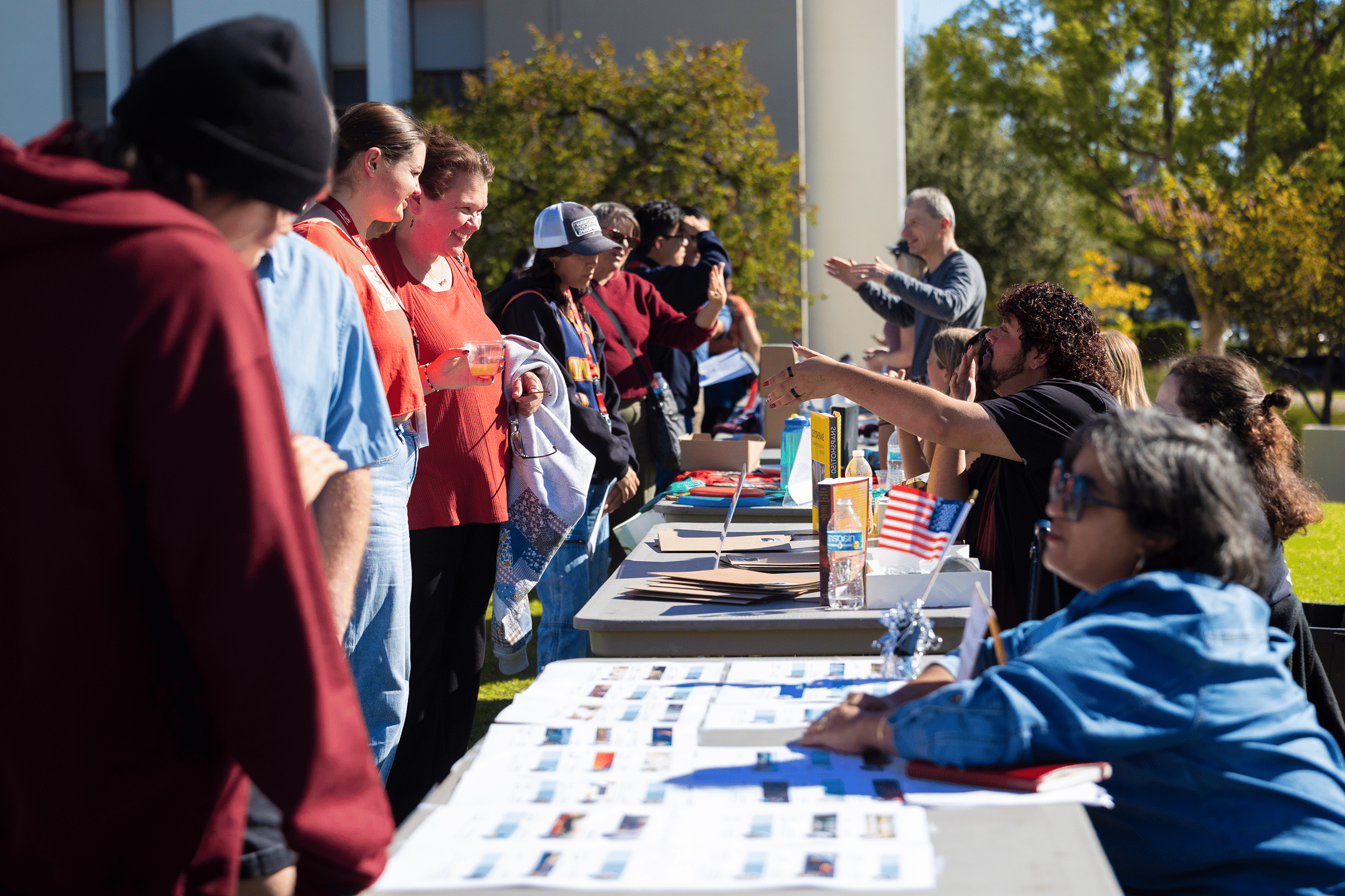 a group of people standing around a table