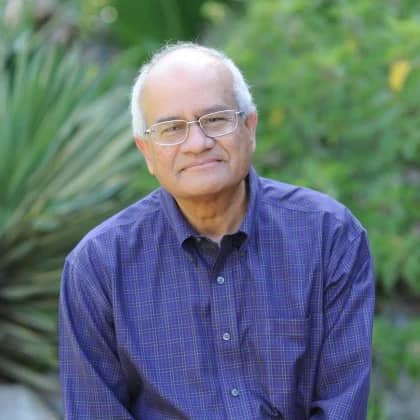 a person wearing glasses and a blue shirt